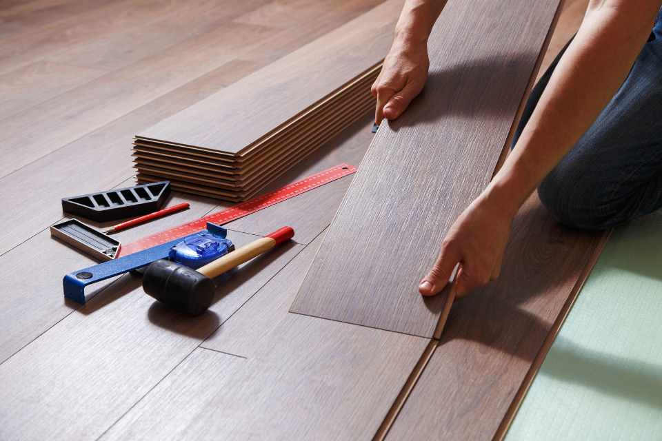 man installing luxury vinyl planks